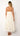 "close-up of ivory midi dress fabric with gold star embroidery, lightweight cotton, boho resort style"