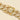 Close-up of the gold Jawa Bracelet highlighting the polished box clasp with pavé cubic zirconia detailing and secure safety latch.