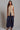 Kaia Vest beige longline tailored vest styled with relaxed navy trousers.