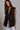 Kaia Vest black sleeveless tailored vest with structured lapels and front button closure.
