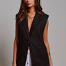 Kaia Vest black longline tailored vest styled with white trousers.