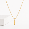 Kimori Necklace gold fish pendant necklace on delicate chain displayed on neutral background