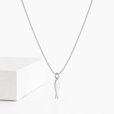 Kimori Necklace silver fish pendant necklace on delicate chain displayed on neutral background.