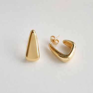 Kira Hoop Earrings featuring polished gold-plated sculptural hoop earrings with a teardrop silhouette, smooth mirror finish, lightweight hollow design, secure post-back closure, and modern statement style, displayed on a soft white background.
