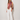 Kirby Top colorful floral scarf-style top with fringe trim styled with white wide-leg pants front view.