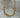 Lanui Necklace by Matte, gold plated necklace with unique two-chain design displayed on stone background