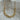 Lanui Necklace by Matte, gold plated necklace with unique two-chain design displayed on stone background