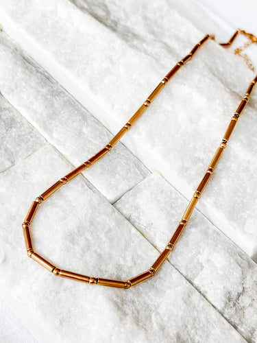 Lester Necklace by Matte, gold filled tubular link chain on marble surface