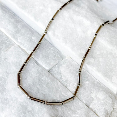 Lester Necklace by Matte, silver tubular link chain on marble surface