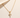 Light Cross Necklace gold-tone chain necklace with crystal cross pendant on neutral background.