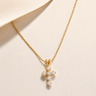 Light Cross Necklace gold-tone chain necklace with crystal cross pendant on neutral background.