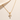 Light Cross Necklace gold-tone chain necklace with crystal cross pendant on neutral background.