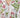 Woman wearing Lissandra Maxi Dress with pink and green floral print walking outdoors in garden setting close up