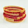 Lolita 6 Loops Bracelet by Matte, gold wire with faceted red gemstone beads.