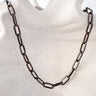 Losa Necklace by Matte, black enamel chain necklace displayed on neutral background