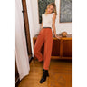 Lourmarin Pant – cropped high-rise pleated pants in terracotta, styled on model.