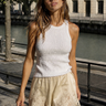 Macarena Shorts cream satin-inspired shorts with lace trim hem styled with a white sleeveless textured tank top.