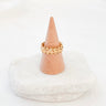 Gold-plated crown-inspired adjustable ring displayed on marble background
