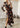 Woman wearing long black floral Managua Dress, showing flowy silhouette and lightweight fabric.