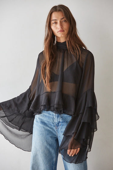 Maruk Blouse showcasing the airy sheer fabric, cascading tiered bell sleeves, relaxed silhouette, and sophisticated movement.
