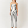Woman wearing a silver metallic bandeau top and matching pants, with shimmering finish, Mave Bandeau Top by Matte.
