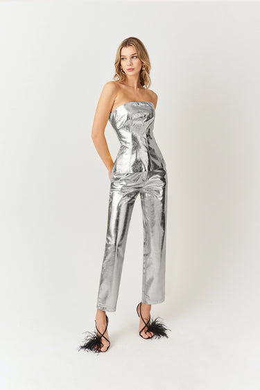 Side view of woman in silver metallic bandeau top with back zip detail, statement piece outfit by Matte.
