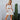 Model wearing white mini skirt with contrast stitching — summer chic look.
