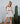 Model wearing white mini skirt with contrast stitching — summer chic look.
