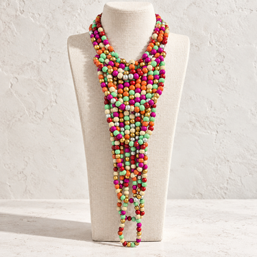 Milat multi-strand colorful beaded statement necklace with layered vibrant beads and a long statement silhouette displayed on a white jewelry bust.