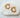 Gold-plated Millan Hoop Earrings (23.5 mm diameter) with starburst edges, displayed on white marble slab.
