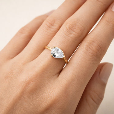 Misuki Ring worn on hand gold thin band pear cut stone ring styled as delicate everyday stacking ring.