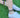 Person wearing colorful bracelet and anklet  on a grassy background
