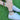 Person wearing colorful bracelet and anklet  on a grassy background