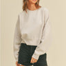 Moonbeam Sweatshirt by Matte – ivory oversized sweatshirt styled with black denim shorts and cap
