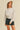 Moonbeam Sweatshirt by Matte – ivory oversized sweatshirt styled with black denim shorts and cap
