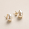 Morath Stud Earrings freshwater pearl teardrop stud earrings with gold posts on neutral background.
