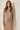 Model wearing the Mur Sweater in a lightweight relaxed knit with a coordinating skirt.