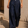 Murish Trouser dark indigo wide-leg trousers showing front pocket detail.