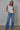 Nala reversible tank in white paired with wide-leg jeans.