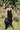 Model wearing black stretch Neir Jumpsuit with v neckline and elastic waist — Matte Concept Store