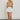 Model wearing white frayed short with drawstring waist and sneakers — casual summer look.
