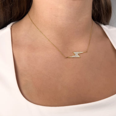 Model wearing Olite gold plated lightning bolt necklace by Matte, minimalist style