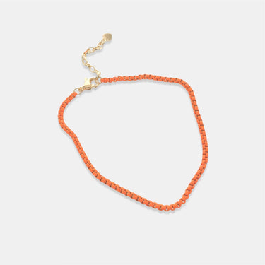 orange beaded anklet  on a light gray background