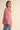 Close-up of Paloma Embroidered Blouse in rouge pink showing embroidered floral details and button-down front by Matte.