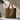 Pampa Tote Bag textured tote bag with leather handles in earthy green tone on neutral background showing structured shape.