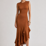 Woman wearing the Pauletti knit midi dress with a fitted silhouette and asymmetric ruffled hem, front view.