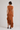 Back view of the Pauletti knit midi dress showing the fitted silhouette and cascading asymmetric hem.