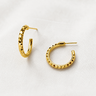 Pisa Hoop Earrings featuring polished gold-plated hoop earrings with a faceted diamond-cut texture, slim rounded silhouette, mirror finish, secure hinged closure, lightweight design, and elegant everyday style.