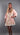Model wearing Floral Mini Dress in pink floral cotton with puff sleeves and crochet lace trim.