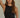 Regi Top black ribbed sleeveless fitted top with modern high neckline worn on model.